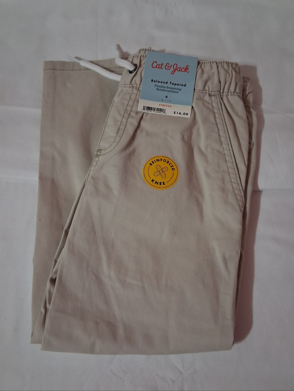 Cat & Jack Kids' Relaxed Tapered Woven Pull-On Pants in khaki.